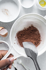 Sifting cocoa powder for baking, a plastic sieve with cocoa powder in it