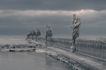 A pier in Port Stanley, Ontario, Canada, with light posts covered in ice. Natural made ice...