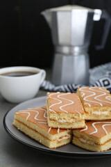 Tasty sponge cakes and hot drink on grey table, closeup