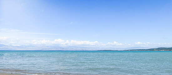 Summer Banner -  Panoramic beach landscape. Closeup beach sea waves and blue summer sky. Empty beach and seascape, horizon.
