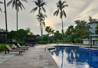 A woman enjoy and relax at the hotel's swimming pool in Lovina, Bali, Indonesia.