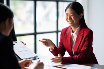 Business teamwork brainstorming meeting process. Business people discussing the charts and graphs showing the results of their successful teamwork.