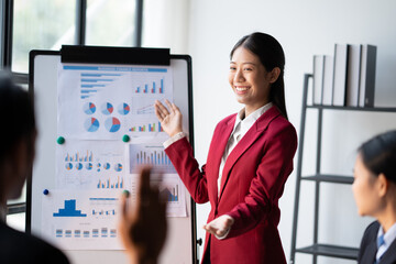 Business teamwork brainstorming meeting process. Business people discussing the charts and graphs showing the results of their successful teamwork.