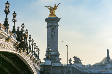 Alexandre III bridge against hazy blue sky in Paris, France - 573749219