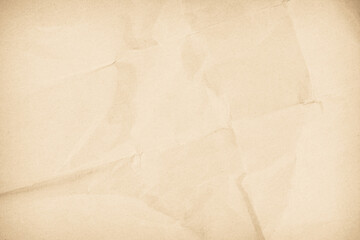 Crumpled paper old folds with copy space for text. Brown recycled craft paper texture as background.