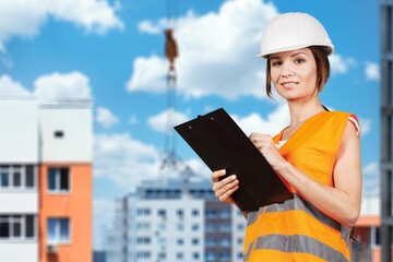 Architect woman with draft plan of building. Construction manager