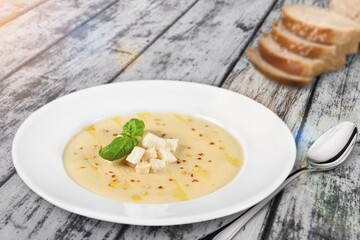 Tasty fresh soup dish in plate with bread