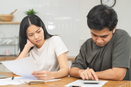 Stressed, Hand Of Asian Young Couple Love Family, Confused By Calculate Expense From Invoice Or Bill, Have No Money To Pay. Mortgage, Loan Causing Debt, Bankruptcy. Debt Problems, Financial People.