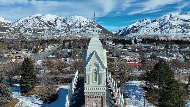 Aerial Brigham City Utah LDS Tabernacle descend. The Church of Jesus Christ of Latter-day Saints, LDS or Mormon Church. Spiritual sacred church. Urban neighborhood in mountain valley. Winter snow.