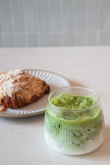 Ice matcha green tea served with croissant