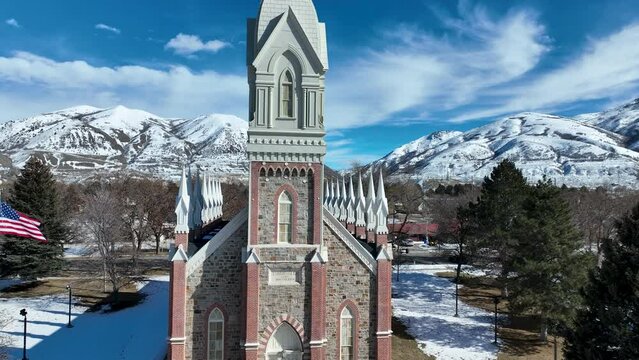 Aerial Brigham City Utah LDS Tabernacle mountain. The Church of Jesus Christ of Latter-day Saints, LDS or Mormon Church. Spiritual sacred church. Urban neighborhood in mountain valley. Winter snow.