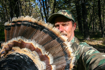 turkey hunter showing the fan tail of a Tom bird