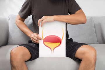 The man holding white paper with pictures of bladder. - obrazy, fototapety, plakaty