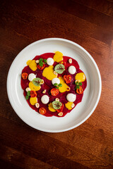 beetroot carpaccio with sauce, on white plate