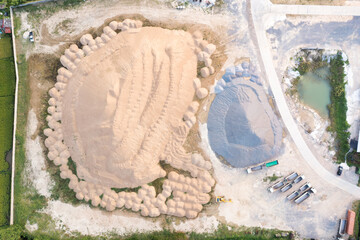 Pile of sand and rock or gravel in site, concrete plant in top view. Heap of aggregate or material...