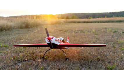 airplane model on the runway at sunset