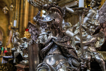 Candlesticks with religious sculptures. Gothic Catholic Cathedral of St. Vitus, Wenceslas and Vojtech in Prague Castle
