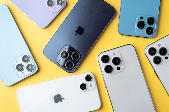 West Bangal, India - January 10, 2022 : Apple iphones in frame with yellow background.
