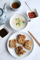 Chinese New Year homemade breakfast meal. Chicken Congee with Turnip Cake aka Lo Bak Go. Delicious and healthy with good synonyms and homonyms meanings