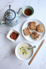 Chinese New Year homemade breakfast meal. Chicken Congee with Turnip Cake aka Lo Bak Go. Delicious and healthy with good synonyms and homonyms meanings