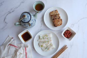 Chinese New Year brealfast meal. Homemade Cheong Fun with Fried Dried Shrimps and Turnip Cake aka Lo Bak Go. Healthy festive dish with good synonyms and homonyms meaning