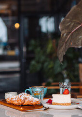 Beautuful Breakfast at the Coffee Shop with Crossant and Cheescake