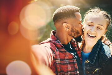 Selfie, kiss and interracial couple on a date in nature for support, love and bonding in Australia. Freedom, trust and black man and woman with kissing affection, quality time and photo for memory