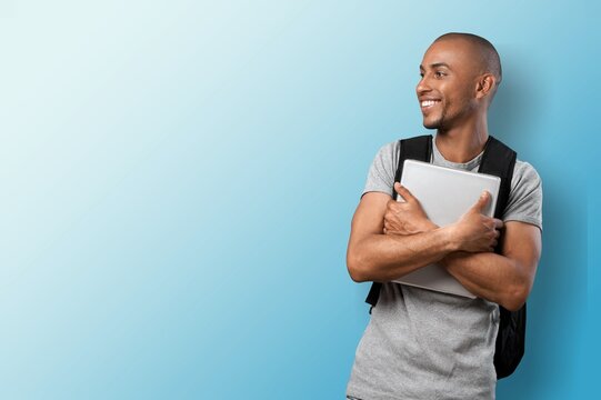 Happy young business person employee holding laptop