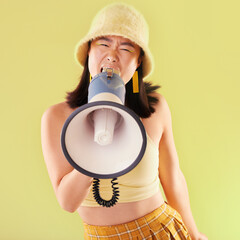 Asian, woman and studio with megaphone for protest, speech and activism for human rights by...