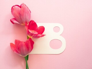 Minimalistic spring greeting card for Women's Day. The number eight and pink tulips with space for text