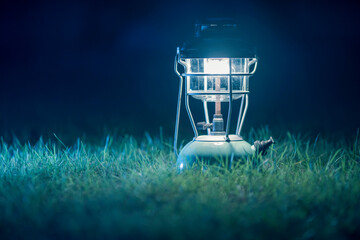 antique kerosene lamp with lights On the lawn at night.Vintage colors picture.	