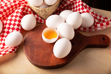 Many chicken eggs on rustic wooden table. Very popular nutritious and economic food product. Closeup image.