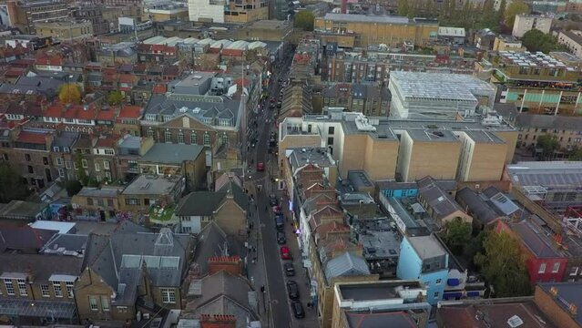 Low aerial flyover of quaint, narrow Brick Lane in London, UK
