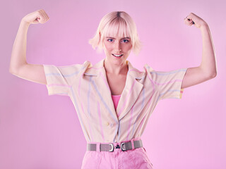 Woman, flexing arm muscle in portrait and smile, power and strong female isolated on pink...