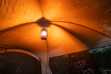 antique kerosene lamp with lights  Light inside the camping tent at night in the pitch-dark forest