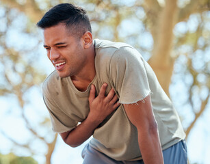 Man, runner and heart attack pain in nature while running outdoors for health or wellness. Sports,...