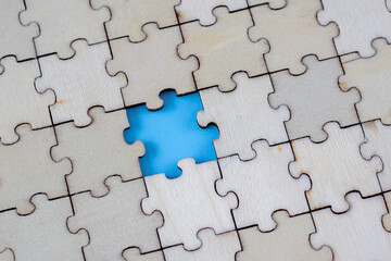 Assembled blank wooden puzzles with emphasis on the missing puzzle.