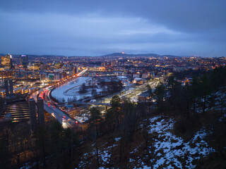Aerial view of Oslo Downtown Skyline, Norway. Financial district and business centers in smart urban city in Europe. Skyscraper and high-rise buildings at night.