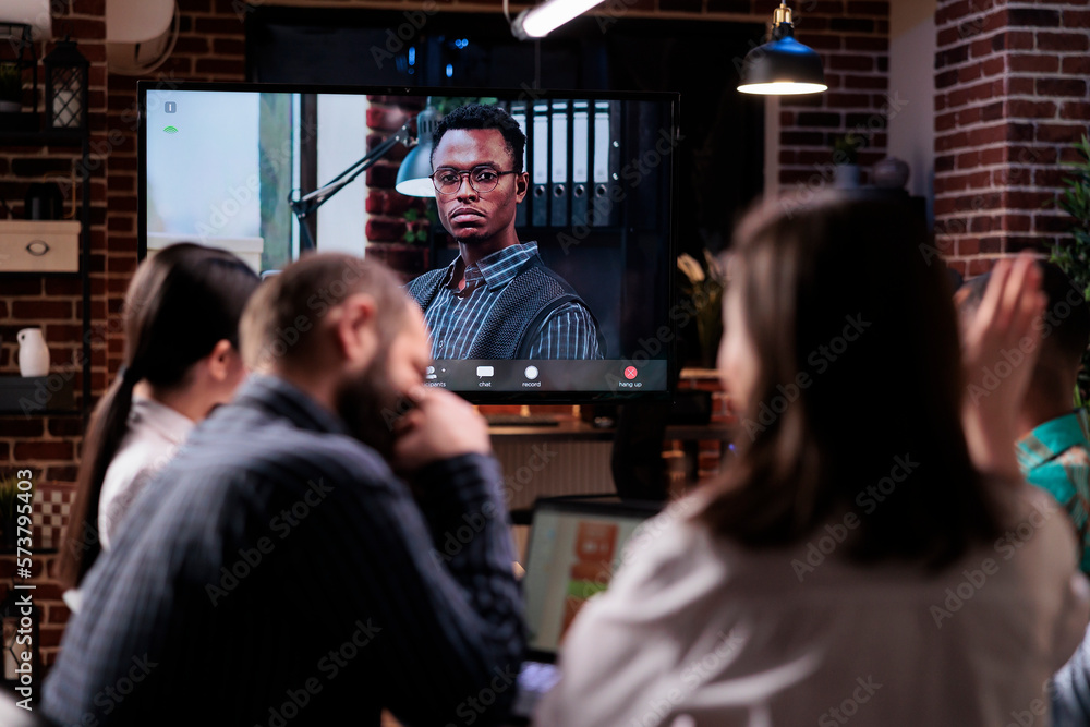 Poster woman raising hand to ask a question while discussing with remote manager during online video call c