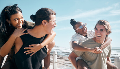 Couple of friends, laughing and piggyback by beach, ocean or sea in social gathering, group...