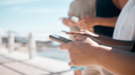 People, hands and phone in networking at beach chatting, texting or social media together in the outdoors. Hand of group on smartphone for communication, typing or data sharing mobile app on mockup
