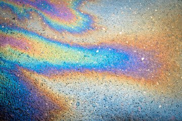 Background texture of oil spill on dark asphalt, parking lot