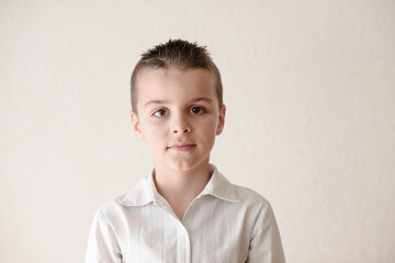 Photo of adorable young happy boy looking at camera.Isolated on the white background