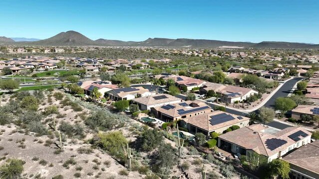 Aerial view of an Arizona neighborhood with solar panels on nearly every roof.