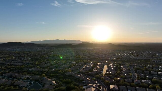 Ultra wide aerial view of vast neighborhoods under the setting Arizona sun.