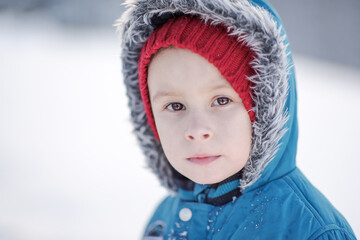 portrait of handsome smiling boy with winter background