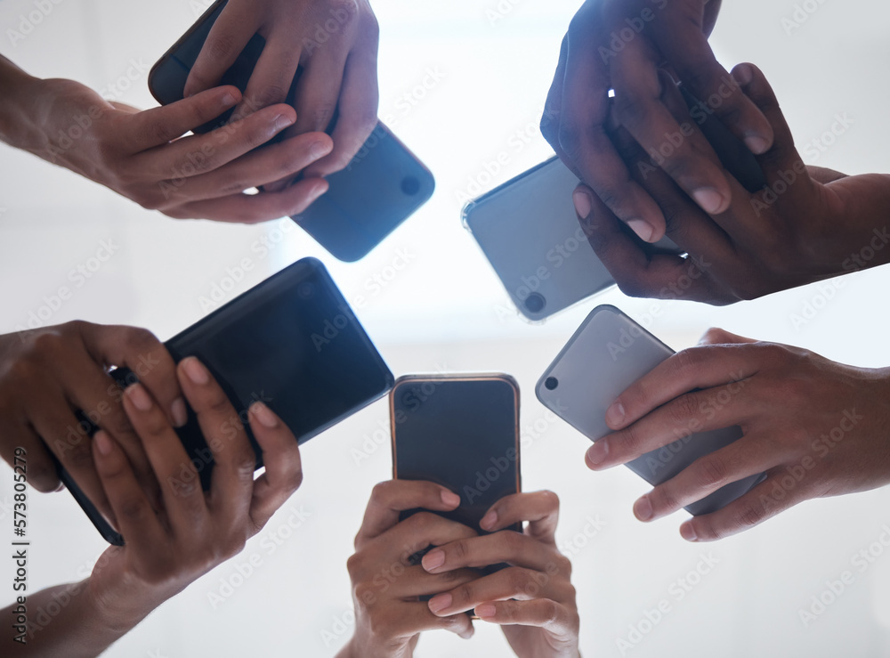 Aufkleber Hands, phone and people networking below on social media, mobile app or chatting together. Low angle hand of group with smartphone in circle for online network share, data sync or team communication