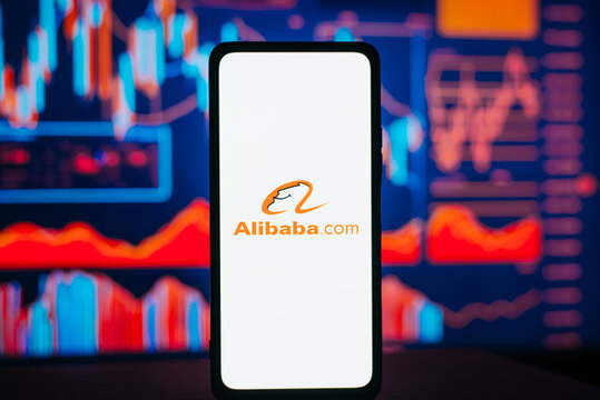 Alibaba and investment, trading and financial business concept. Alibaba company logo on smartphone against background of stock exchange loss chart. Astana, Kazakhstan 15.02.2023