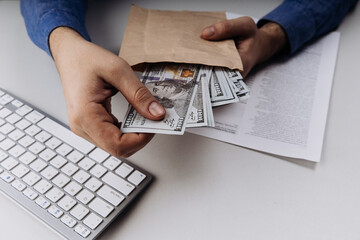 Businessman with dollar bribe in an envelope. Top view. Corruption concept