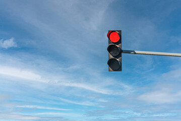 Modern traffic light with red light in front of cloudless sunny blue sky - obrazy, fototapety, plakaty